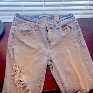 These are faded ripped blue jeans mid rise